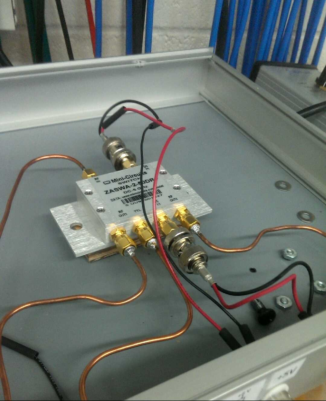 RF circuitry assembled in a box. The circuit has the shape of an octopus.